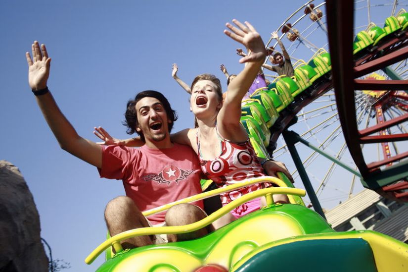 24736329 - teenage couple on roller coaster